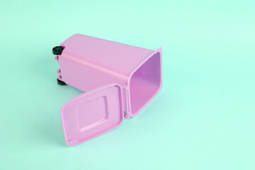 Empty pink toy trash can on blue background