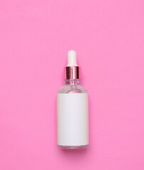 Mockup serum bottle on pink background. Creative trendy beauty flat lay