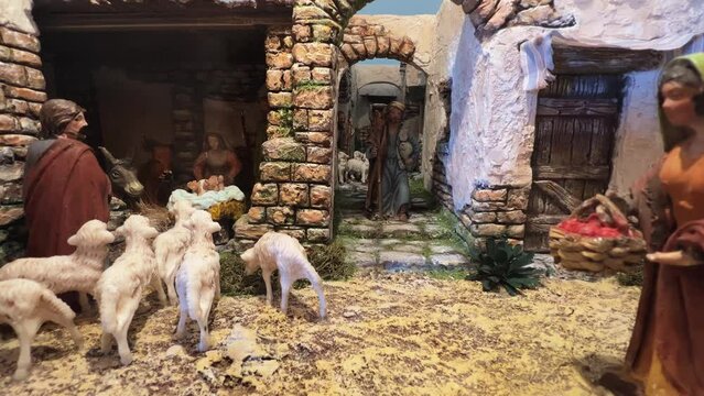 Christmas representation of religious scene of nativity with painted handmade figurine. Zoom in