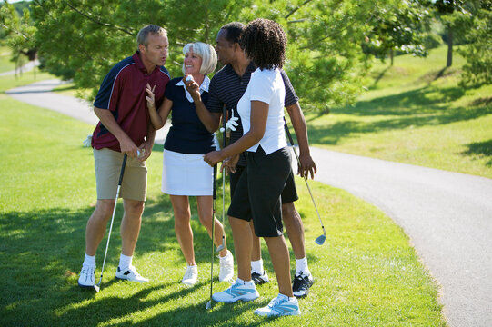 Couples Chatting on Golf Course