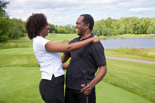 Couple Embracing on Golf Course