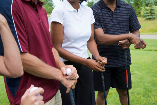 Close-up of People Standing on Golf Course