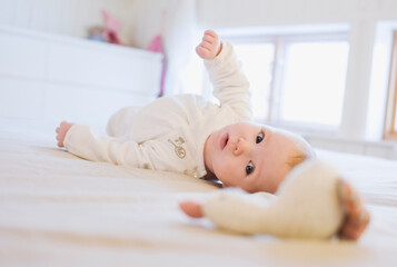 Baby Lying on Floor with Toy