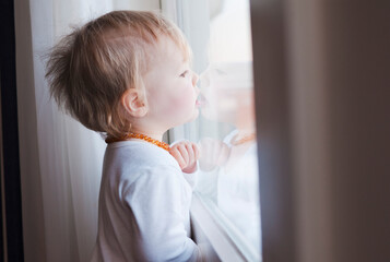 Portrait of Baby Girl Looking out Window
