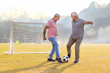 Senior friends playing football together.
