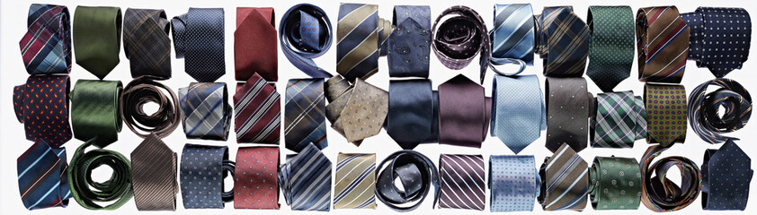 Assortment of ties rolled-up on white background in studio