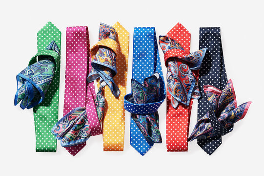 Six, coloured ties with handkerchiefs on white background in studio
