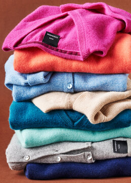 Stack of multicolored cashmere pullover sweters in studio