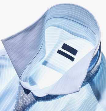 Detail of a blue shirt with tie on white background, studio shot