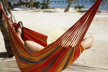 Woman Lying in Hammock on Beach