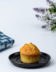 muffin on black plate with white background