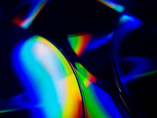 round DVDs with bright multi-colored rainbow highlights on the surface close-up