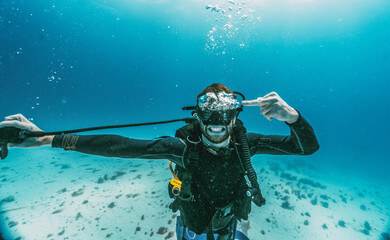 scuba diver doing middle finger with bubbles