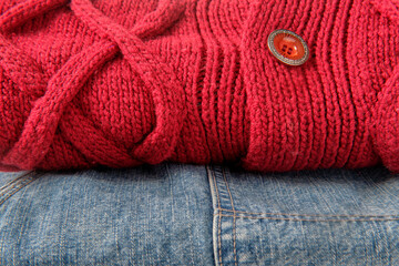 Fototapeta na wymiar light blue cotton jeans and a crimson wool jumper with a button