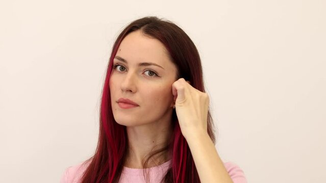 Woman puts earplugs in her ear. Girl uses earplugs to sleep peacefully. Earplugs are a piece of soft plastic that is inserted into your ear canal to protect your ears from loud sounds, water, wind or