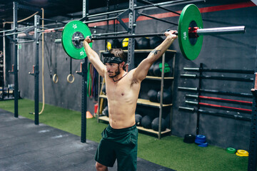Strong Man lifting weight in a gym