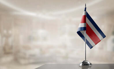 Fototapeta premium A small Costa Rica flag on an abstract blurry background
