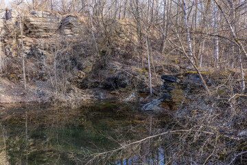 Abandoned quarry with an overgrown forest