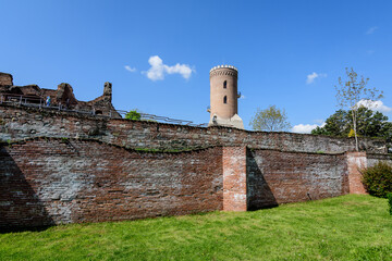 Chindia Park (Parcul Chindia) near the old stone buildings and ruins of the The Royal Court of Targoviste (Curtea Domneasca) in the historical part of the city  in a sunny spring  day, in Romania