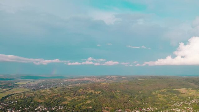 Clouds with rain rolling over a rural settlement in summer. High resolution drone video. 4K.