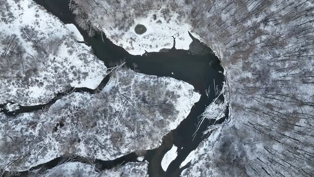 River winter floodplain snow meander delta drone aerial inland video shot in sandy sand alluvium freezing cold frost, benches forest and lowlands wetland swamp, quadcopter view flying fly flight show