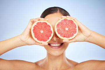 Beauty, health or woman with grapefruit for skincare wellness, facial cleaning or natural vitamin C in studio. Smile, cosmetics or happy girl model marketing fruit to detox for a glowing smooth face