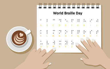 World Braille Day, hands reading braille alphabet with coffee on the desk