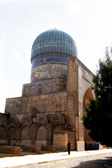 The Bibi-khanum mosque among the greenery against the sky in Samarkand in Uzbekistan. Travel concept.