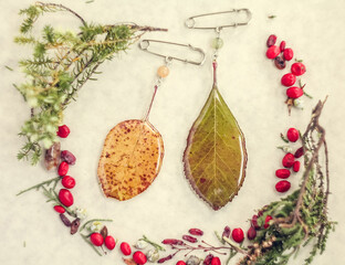 Close up brooches with leaves in epoxy resin concept photo. Top view photography with light display...