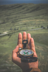 Close up woman holding compass concept photo. Navigation at hike. First view person photography...