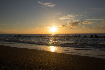 evocative image of sunset over the calm sea on a beautiful day