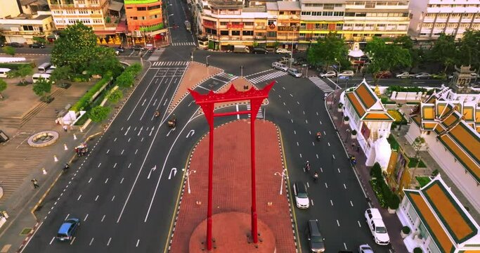An aerial view of Red Giant Swing and Suthat Thepwararam Temple at sunset scene, The most famous tourist attraction in Bangkok, Thailand.