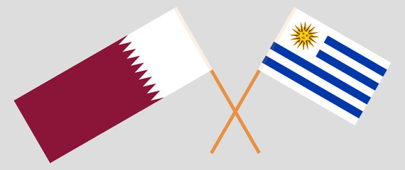 Crossed flags of Qatar and Uruguay. Official colors. Correct proportion