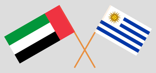 Crossed flags of the United Arab Emirates and Uruguay. Official colors. Correct proportion