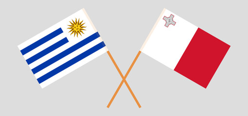Crossed flags of Uruguay and Malta. Official colors. Correct proportion