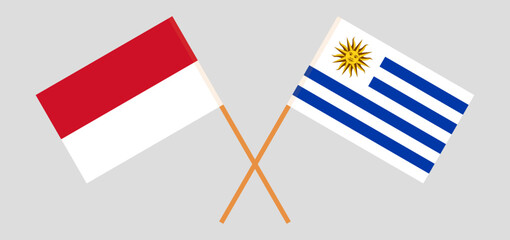 Crossed flags of Indonesia and Uruguay. Official colors. Correct proportion