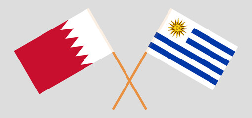 Crossed flags of Bahrain and Uruguay. Official colors. Correct proportion