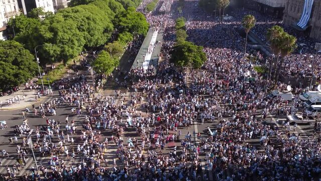 Aerial tilt down shot of many fans with Argentinian flags on 9 De Julio Avenue in Buenos Aires after win of World Cup