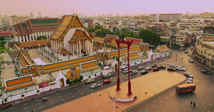 An aerial view of Red Giant Swing and Suthat Thepwararam Temple at sunset scene, The most famous tourist attraction in Bangkok, Thailand.