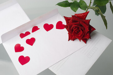 Letter, red hearts and roses on white. Place for your text.