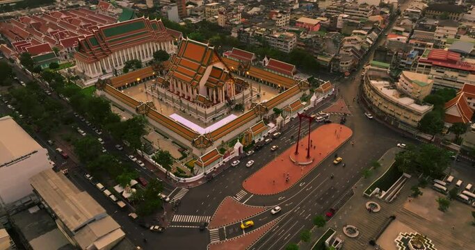 An aerial view of Red Giant Swing and Suthat Thepwararam Temple at sunset scene, The most famous tourist attraction in Bangkok, Thailand.
