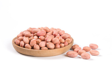 Raw peanuts in a wooden plate isolated on white background.