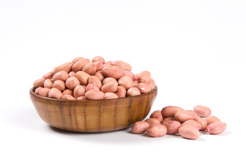 Raw peanuts in a wooden plate isolated on white background.