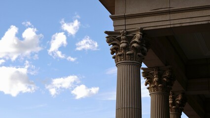 Corinthian columns against cloudy sky