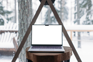 laptop on the table with space for text. winter outside the window 14-inch MacBook Pro