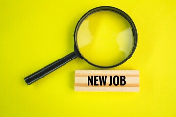 magnifying glass with the word new job. the concept of finding a new job