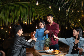 Young couple and friends get together for a holiday party.