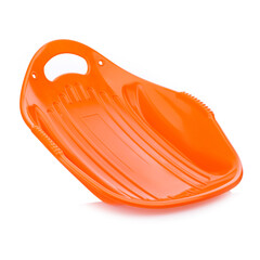 Children's plastic orange sled isolated on a white background. Sleds for skiing downhill in winter. Children's toys. Slide board