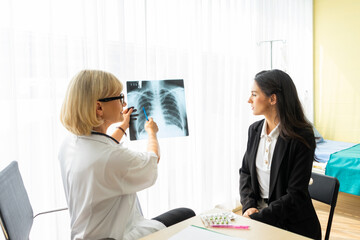 Doctor working in the doctor office and desperately explaining about X-rays to patients.