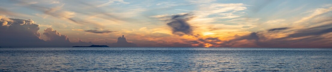dramatic clouds during sunset over the sea, panoramic view